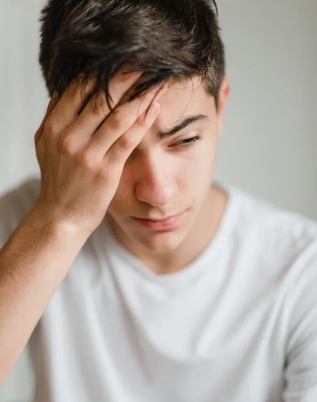 Patient experiencing a headache before chiropractic treatment
